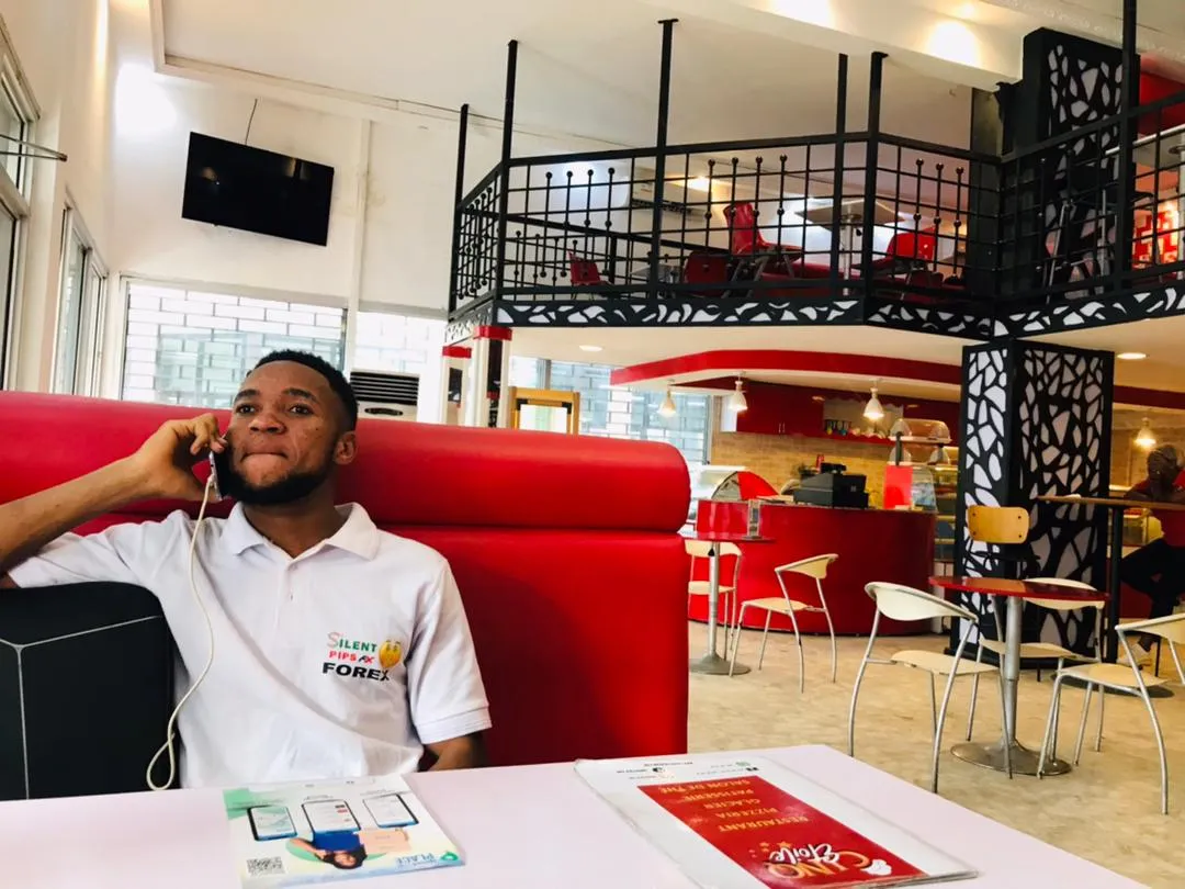 Nsom Emmanuel on a phone call at an office desk
