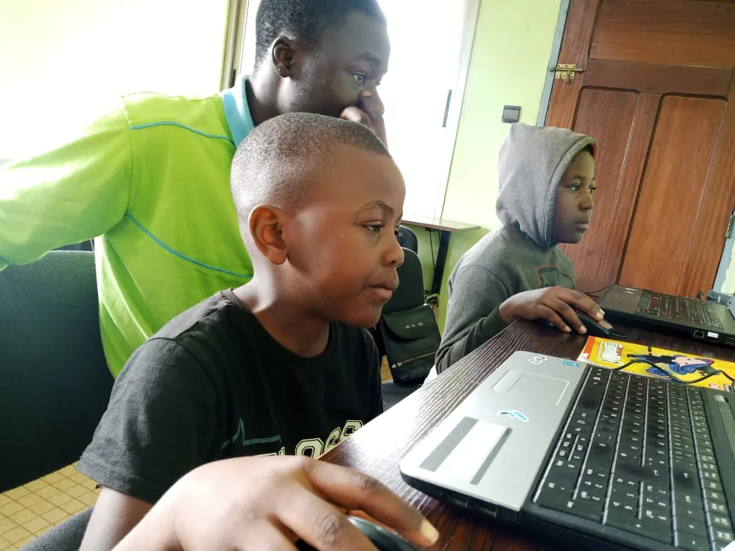 Children learning on a laptop during the Skye8 IT training